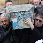 Liam Gallagher Carries Stone Roses' Mani's Coffin at Manchester Funeral