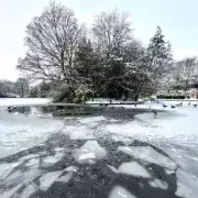 Teenager rescued after falling through ice at Stoke park lake