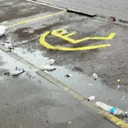 Fake Disabled Parking Sign Painted on Birmingham Street in Parking Dispute