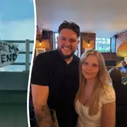 Man Asks Woman to Be Girlfriend with Bedsheet Message on Bridge