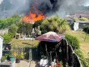 50ft flames rip through Tamworth gardens as woman rushed to hospital